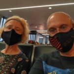 Pam and David, with masks, waiting for our flight at the airport in Boston