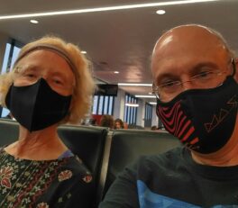 Pam and David, with masks, waiting for our flight at the airport in Boston